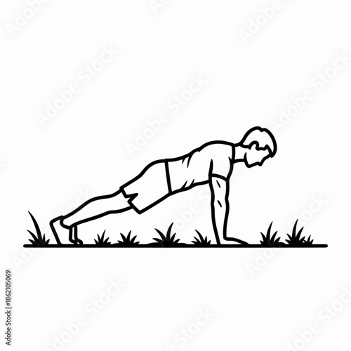 Man practicing plank core exercise on green grass