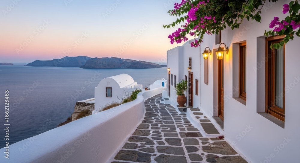 Fototapeta premium Serene Coastal Village Scene: A picturesque village scene, capturing the idyllic coastal life. The clean lines of the white buildings and cobblestone path leading towards a calm sea and island.