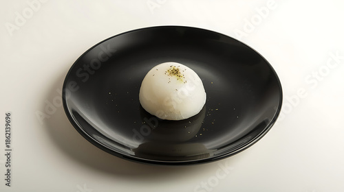 Single sweet treat on black plate