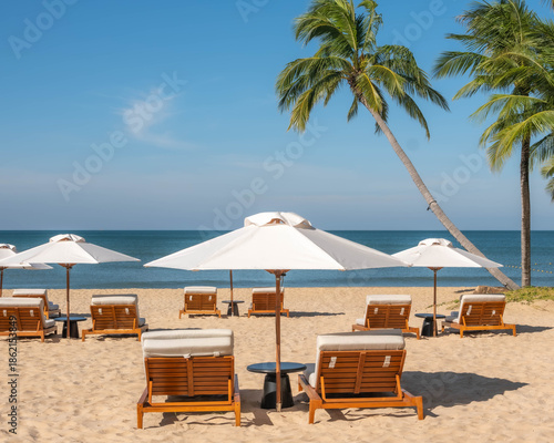 Sunny Tropical Beach Scene with Empty Lounge Chairs and Palm Trees