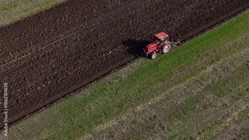Tractor plows fields in autumn