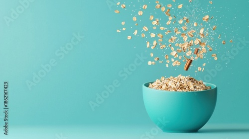 A vibrant turquoise bowl filled with oats shows oats cascading in the air, creating a dynamic and fresh food scene.