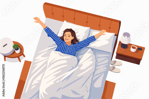 A happy woman waking up joyfully and stretching with her arms open in bed.