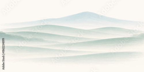 A serene winter landscape of snow covered mountains and misty hills at sunrise creates an abstract nature background with clouds over a blue forest valley