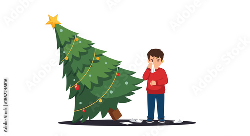 Sad little boy crying and wiping his eyes next to a fallen Christmas tree decorated with ornaments and a golden star.