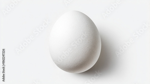 An egg in a white shell on a white or gray background. The symbol of Easter.