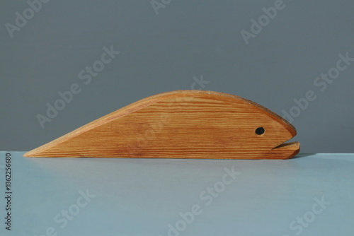 A wooden fish figurine close-up, with a distinct wood texture
