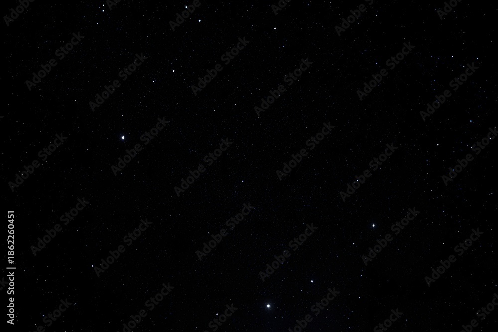 Fototapeta premium A black sky with a few stars in it