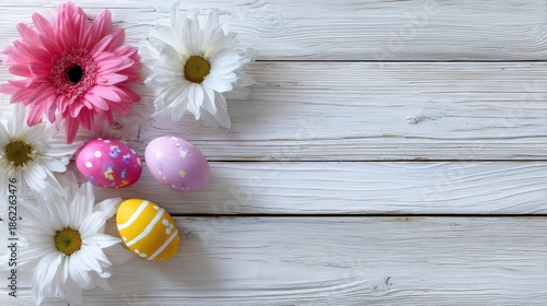 Bright flowers and decorated eggs on a wooden table for Easter celebration in springtime