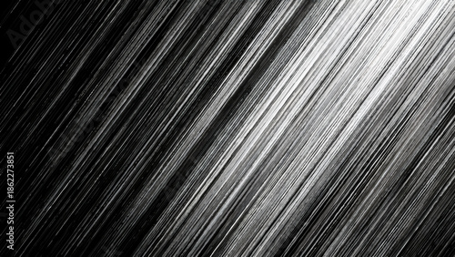 A striking abstract image featuring diagonal lines creating a dynamic and textured grayscale pattern across the composition