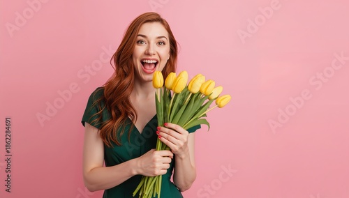 Woman Holds Yellow Tulips in Front of Pink Background, Smiling Brightly Durin...
