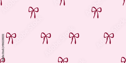 Seamless pattern with hand-drawn ribbon bows on a light pink background