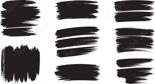 Several expressive black paint brush strokes creating grunge textures and marks on a pure white background