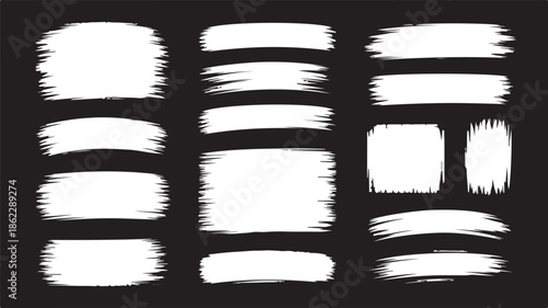 Numerous expressive white paint brush strokes and grunge texture elements displayed on a deep black background