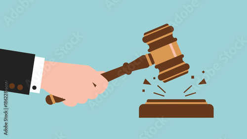 Gavel being struck by hand against a sound block in a courtroom setting from a slightly angled viewpoint