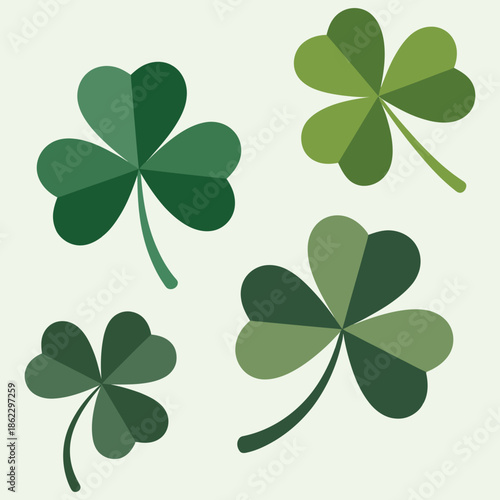 Four stylized green shamrocks with varying shades of green leaves, depicted as simple graphic elements on a light background.