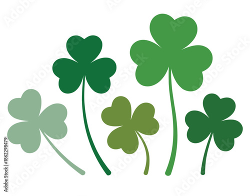 Five green shamrocks and clovers in various shades and sizes on a white background, symbolizing luck and St. Patrick's Day.