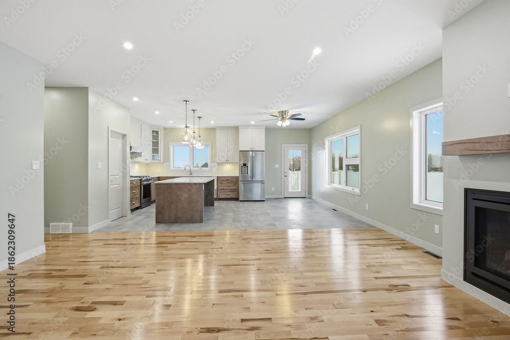 Fototapeta premium Large open living room with a fireplace and a kitchen