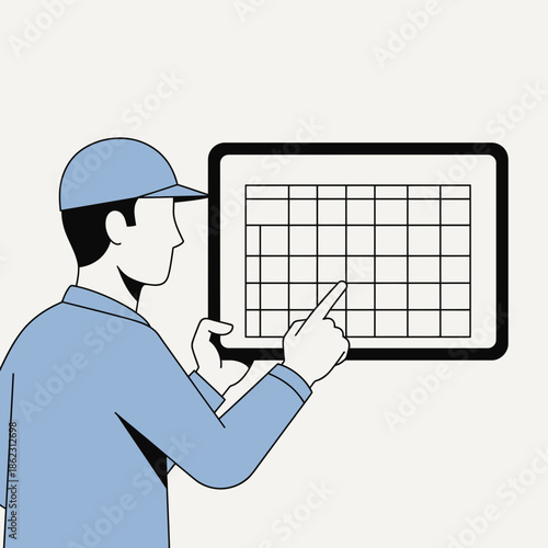 Person in blue shirt and cap points at a grid on a screen.