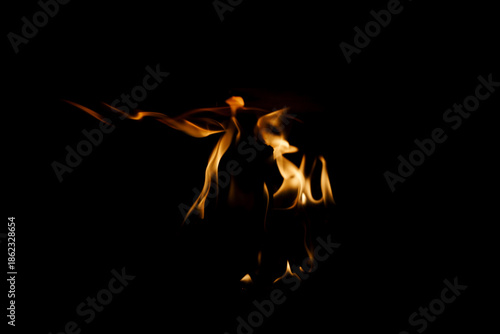 Close-up of a fire in a fireplace, against a black background