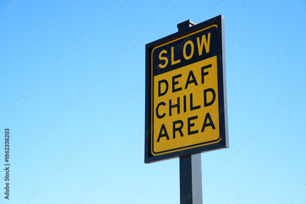 Obraz premium Warning Sign on Residential Street Urging Caution because of a Deaf Child Living Nearby