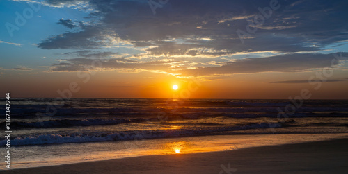 Sun setting over the Pacific Ocean from Mission Beach in San Diego, California, USA taken on June 1, 2025