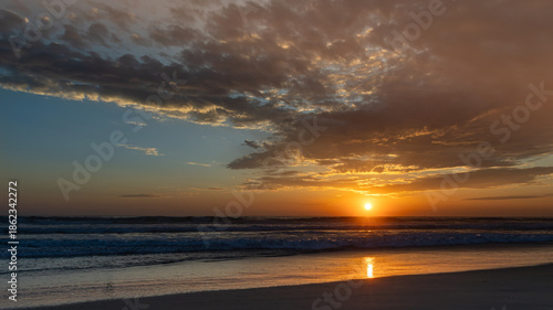 Sun setting over the Pacific Ocean from Mission Beach in San Diego, California, USA taken on June 1, 2025