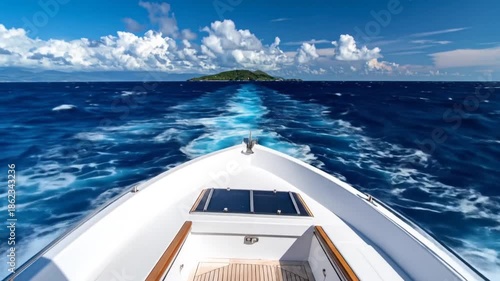 A boat's bow cuts through the sea towards a distant island under a bright, cloudy sky