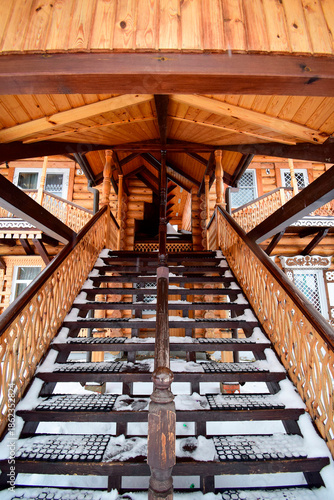 the steps of the staircase leading to the wooden house