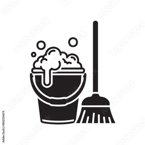 Cleaning supplies with bucket and broom filled with soapy water