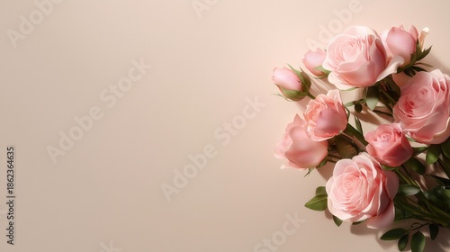 Elegant pink roses with green leaves arranged on soft pastel background.