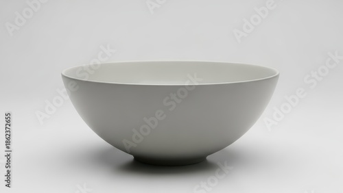 Simple elegant white ceramic bowl on gray background