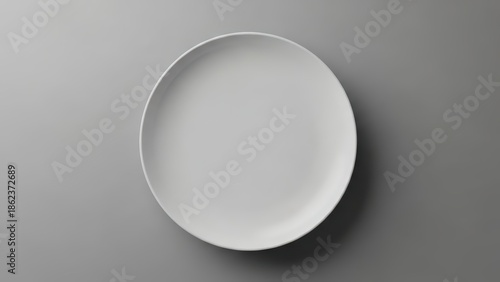 Simple white plate on gray background for food presentation