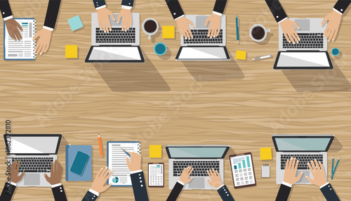 Flat design illustration of a diverse business team working collaboratively at a long wooden table with laptops, coffee, and documents, viewed from above