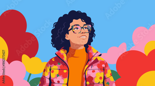 Stylish young woman with dark curly hair and colorful glasses wears a floral jacket, looking up with a hopeful smile against a background of large abstract flowers