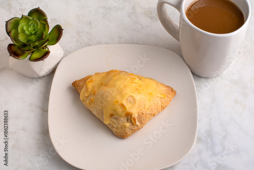 orange scone with a cup of coffee