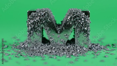 Magnetic Attraction - Iron Filings Form the Letter M on a Green Background.
