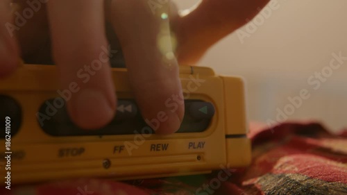 Woman rewinding and pressing play on portable cassette player. - extreme close up