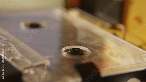 Retro portable cassette player rewinding compact cassette tape - close up