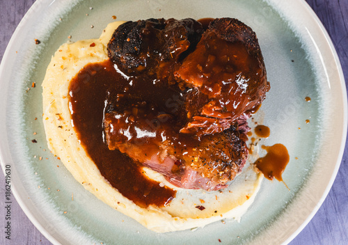 Tablou pe pânză Beef shin with bone served on a plate with creamy mashed potatoes