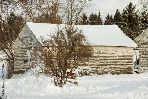 An old wooden garage in the snow