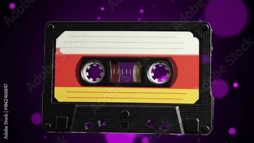 A close-up view of a cassette tape on a purple background with spots.