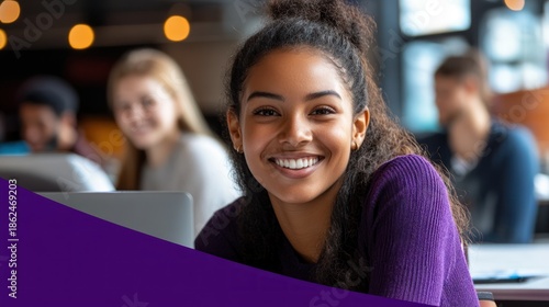 Smiling young woman working on laptop in bright room