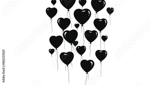 Black heart shaped balloons floating in air
