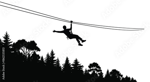 Silhouette of an adventurous person zip lining across the sky high above a dense forest canopy during a thrilling outdoor extreme sport activity
