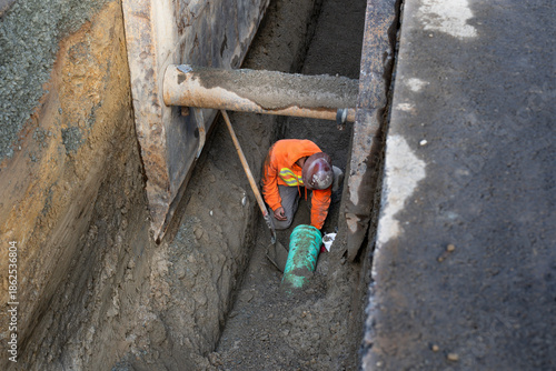 Принти на полотні Construction worker in deep trench protected by Trench Box, coffin, while instal
