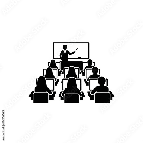 A presenter addresses an audience in a computer lab setting with multiple screens and laptops