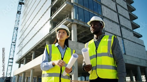 Wallpaper Mural Diverse Construction Engineers Inspecting Building Project with Blueprints at Modern Construction Site Torontodigital.ca