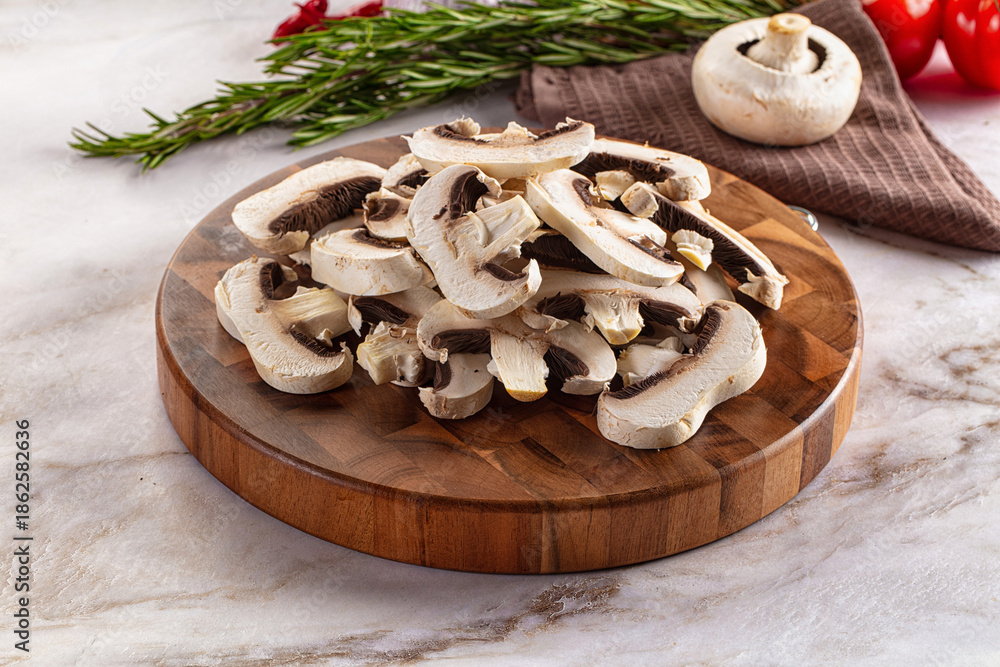 Fototapeta premium Raw champignon slices on the board