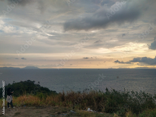 Beautiful sunset over the sea and the mountain in the background.